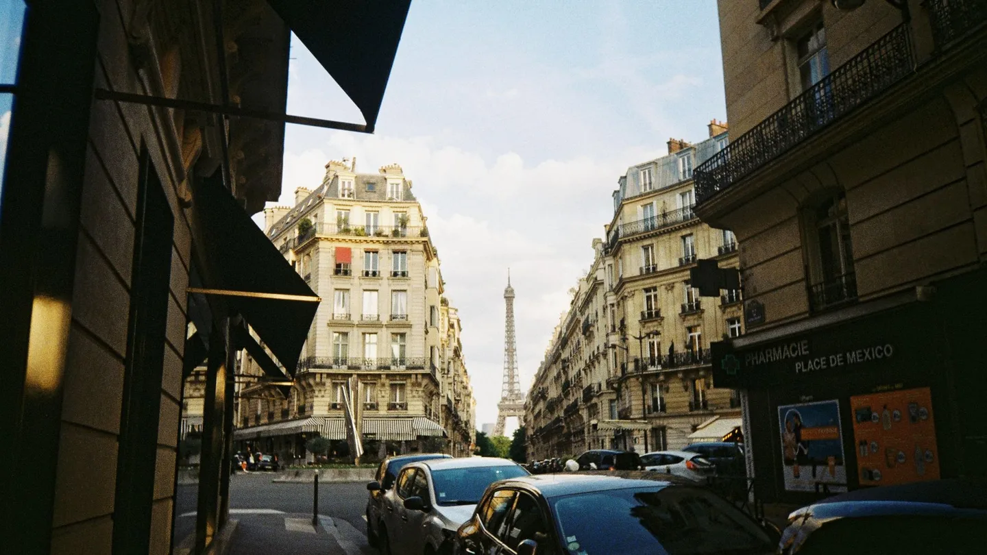 Paris street with the Eiffel Tower visible above the city